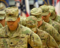 FORT KNOX, Ky - 1st Theater Sustainment Command Soldiers bow their heads in prayer during a redeployment ceremony held here at Fort Knox. 1st TSC welcomed home 25 of its Soldiers from Kuwait at a redeployment ceremony Dec. 13 at the Sadowski Center here on post.