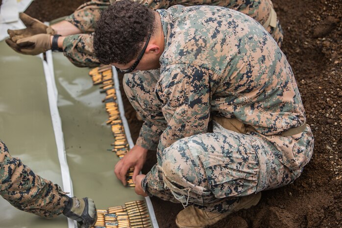 Sgt. Payton S. Lawler aligns various small-arms ammunition on detasheet Sept. 3, 2018 at Camp Fuji, Japan. Marines with Explosive Ordnance Disposal Company, 9th Engineer Support Battalion, 3rd Marine Logistics Group, use detasheet, a rubberized explosive, for large-scale disposal. EOD Company Marines validated proficiency and prepared for worldwide mission deployment in support of III Marine Expeditionary Force by testing their ability to disable and dispose of explosives. Lawler is a native of Green Bay, Wisconsin. (U.S. Marine Corps photo by Lance Cpl. Armando Elizalde)