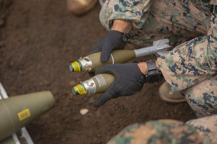 Sgt. Juan Lira, left, and Sgt. Payton S. Lawler carry 155 mm artillery rounds Sept. 3, 2018 at Camp Fuji, Japan. Explosive Ordnance Disposal Marines detonate different types of munitions with explosives during large-scale disposal. EOD Company Marines validated proficiency and prepared for worldwide mission deployment in support of III Marine Expeditionary Force by testing their ability to disable and dispose of explosives. Lira, an EOD technician, is a native of Edinburg, Texas. Lawler, an EOD technician, with EOD Company, 9th Engineer Support Battalion, 3rd Marine Logistics Group is a native of Green Bay, Wisconsin. (U.S. Marine Corps photo by Lance Cpl. Armando Elizalde)