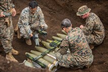 Explosive Ordinance Disposal Technicians place Composition C-4 blocks on 155 mm artillery rounds Sept. 3, 2018 at Camp Fuji, Japan. Explosive Ordnance Disposal Marines detonate different types of munitions with explosives during large-scale disposal. EOD Company Marines validated proficiency and prepared for worldwide mission deployment in support of III Marine Expeditionary Force by testing their ability to disable and dispose of explosives. (U.S. Marine Corps photo by Lance Cpl. Armando Elizalde)