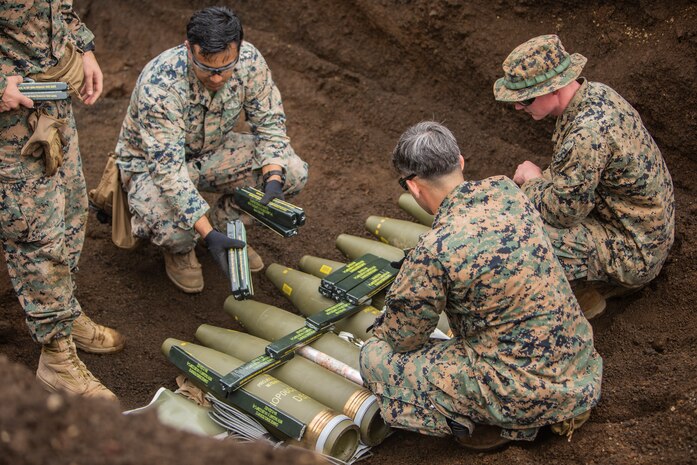 Explosive Ordinance Disposal Technicians place Composition C-4 blocks on 155 mm artillery rounds Sept. 3, 2018 at Camp Fuji, Japan. Explosive Ordnance Disposal Marines detonate different types of munitions with explosives during large-scale disposal. EOD Company Marines validated proficiency and prepared for worldwide mission deployment in support of III Marine Expeditionary Force by testing their ability to disable and dispose of explosives. (U.S. Marine Corps photo by Lance Cpl. Armando Elizalde)