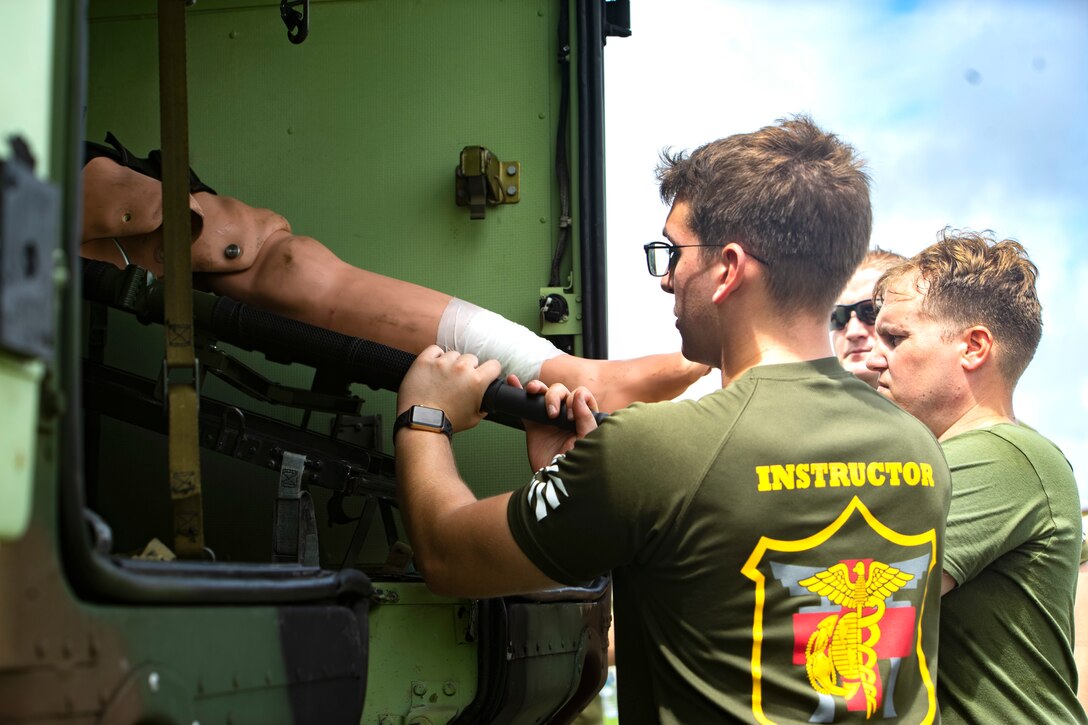 Medical personnel assigned to 3rd Medical Battalion, 3rd Marine Logistics Group, escort a simulated casualty during Navy Medicine Augmentation Program pre-deployment training at Medical Simulation Training Center South, Okinawa, Japan, Aug. 25, 2018.  Medical personnel with 3rd Medical Bn., 3rd MLG, worked with medical augments to prepare Role II medical facilities. Role II facilities provide a place for injured service members to be received while providing enhanced capabilities such as ultrasound, X-ray and surgery. (U.S. Marine Corps photo by Cpl. Joshua Pinkney)