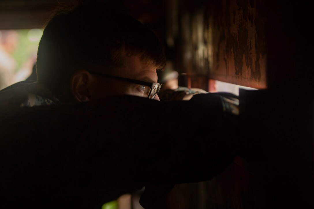 Sgt. Tyler E. Bradley watches an explosion through an eye slit of a bunker Sept. 6, 2018 at Camp Fuji, Japan. Post blast analysis allows Marines to determine if the explosives have been properly disposed of, their composition and the direction they came from. Explosive Ordnance Disposal Marines prepared for worldwide mission deployment in support of III Marine Expeditionary Force by testing their ability to disable and dispose of explosives. Bradley, a native of a Dallas, Texas, is an EOD technician with EOD Company, 9th Engineer Support Battalion, 3rd Marine Logistics Group. (U.S. Marine Corps photo by Pfc. Mark Fike)