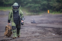 Sgt. Scott N. Schaller walks back from X-raying a suitcase Sept. 5, 2018 at Camp Fuji, Japan. Explosive Ordnance Disposal technicians use an X-ray to determine if they can safely inspect items. EOD Company Marines validated proficiency and prepared for worldwide mission deployment in support of III Marine Expeditionary Force by testing their ability to disable and dispose of explosives. Schaller, a native of Easton, Pennsylvania, is with EOD Company, 9th Engineer Support Battalion, 3rd Marine Logistics Group. (U.S. Marine Corps photo by Lance Cpl. Armando Elizalde)