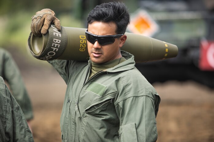 Sgt. Juan Lira carries a 155 mm artillery round Sept. 6, 2018 at Camp Fuji, Japan. Marines with Explosive Ordnance Disposal Company, 9th Engineer Support Battalion, 3rd Marine Logistics Group validated proficiency and prepared for worldwide mission deployment in support of III Marine Expeditionary Force while at Camp Fuji. Lira, an EOD technician, with EOD Company, 9th Engineer Support Battalion, 3rd Marine Logistics Group, is a native of Edinburg, Texas. (U.S. Marine Corps photo by Lance Cpl. Armando Elizalde)