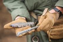 Gunnery Sgt. Joshua Firth holds fragments from an artillery casing Sept. 6, 2018 at Camp Fuji, Japan. Explosive Ordnance Disposal Marines detonate different types of munitions with explosives during large-scale disposal. EOD Company Marines validated proficiency and prepared for worldwide mission deployment in support of III Marine Expeditionary Force by testing their ability to disable and dispose of explosives. Firth, an EOD technician, with EOD Company, 9th Engineer Support Battalion, 3rd Marine Logistics Group, is a native of Seaside, Oregon. (U.S. Marine Corps photo by Lance Cpl. Armando Elizalde)