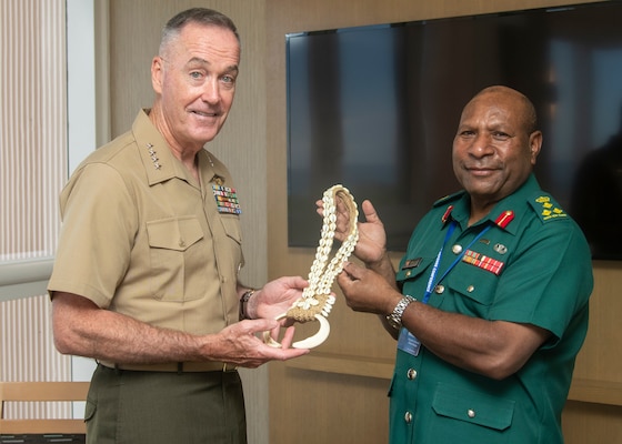 Marine Corps Gen. Joe Dunford, chairman of the Joint Chiefs of Staff, receives a gift from Papua New Guinea Army Brig. Gen. Gilbert Toropo, Commander, Papua New Guinea Defense Force, during the Indo-Pacific Chief of Defense conference in Waikiki, Hawaii, Sept. 10, 2018.