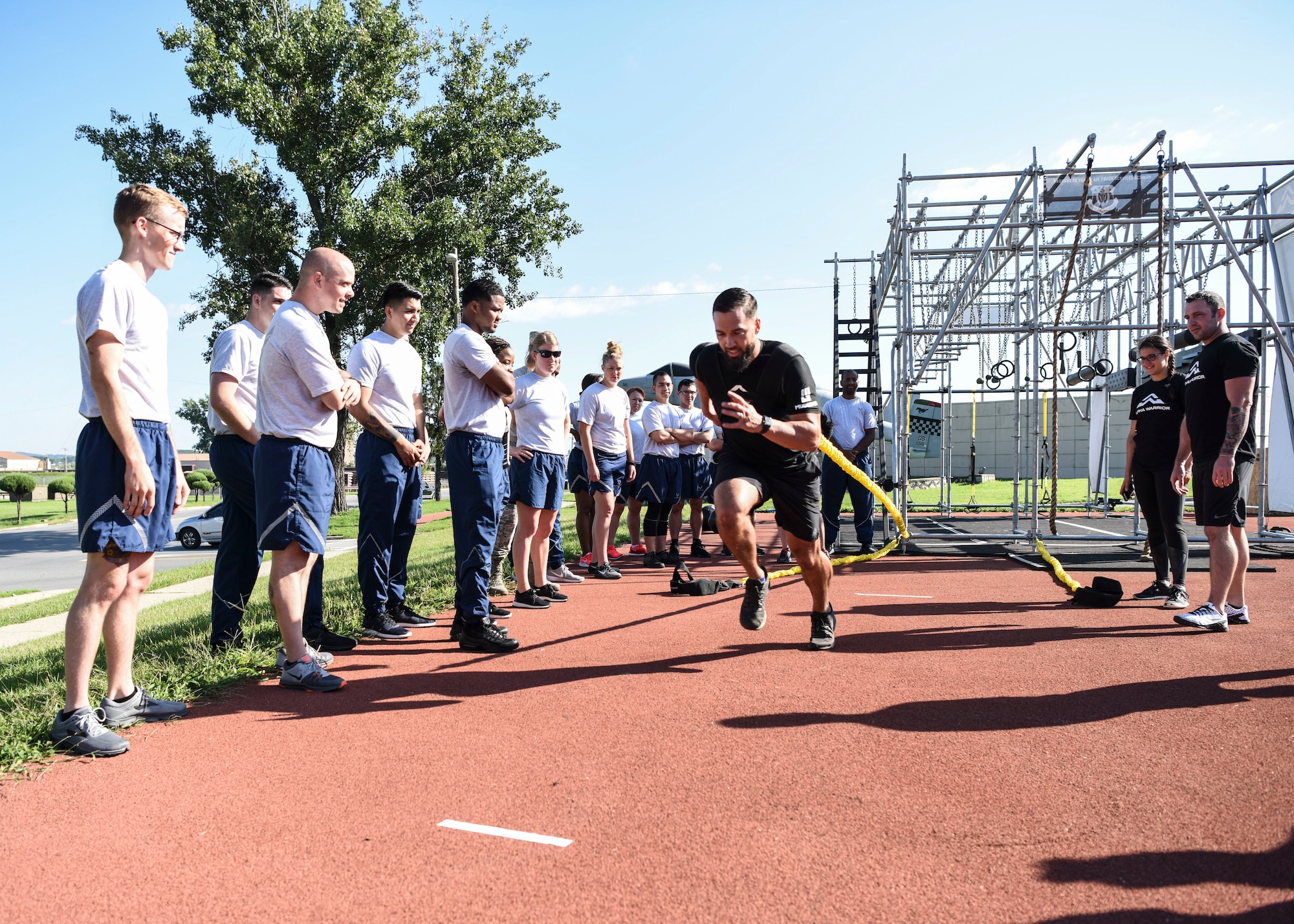 Chad Leath, Alpha Warrior fitness coach, demonstrates how to use a weighted bungee cord for resistance sprints during an Alpha Warrior Battle Rig instructional course at Osan Air Base, Republic of Korea, Sept. 11, 2018. Members of Team Osan participated in the two-day course which included battle rig familiarization, how to coach others on the battle rig, and how to use the battle rig with proper safety measures. (U.S. Air Force photo by Airman 1st Class Ilyana A. Escalona)
