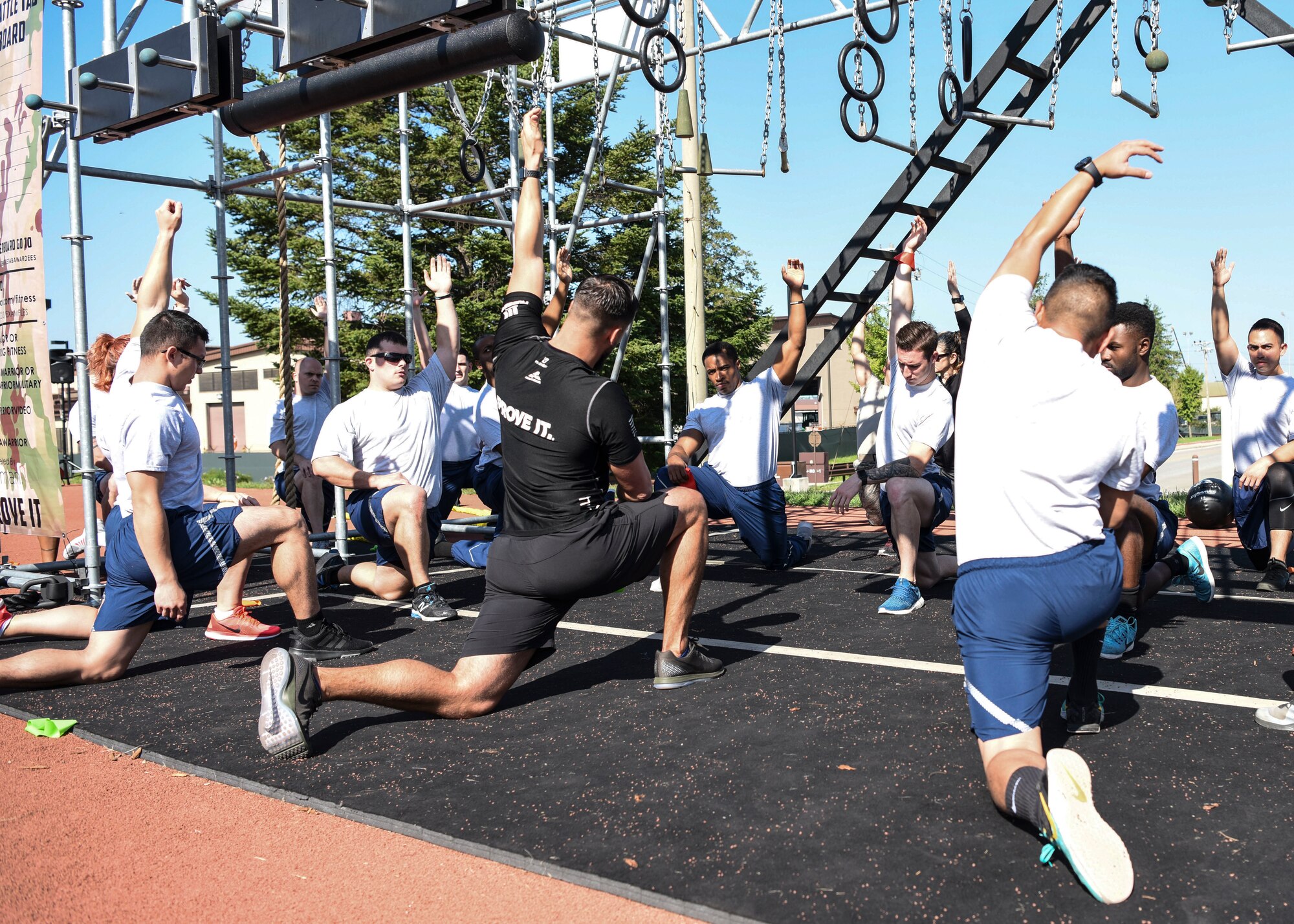 Chad Leath, Alpha Warrior fitness coach, leads a stretch warm-up during an Alpha Warrior Battle Rig instructional course at Osan Air Base, Republic of Korea, Sept. 11, 2018. Members of Team Osan participated in the two-day course which included battle rig familiarization, how to coach others on the battle rig, and how to use the battle rig with proper safety measures. (U.S. Air Force photo by Airman 1st Class Ilyana A. Escalona)