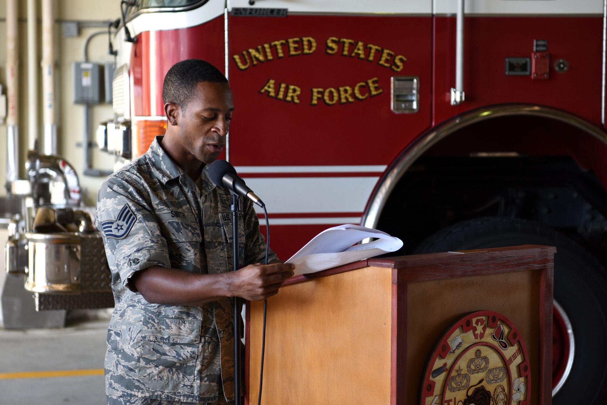 U.S. Air Force Staff Sgt. Devon Smith, 51st Civil Engineer Squadron fire and emergency services flight lead firefighter, reads the names of emergency responders who gave their lives rescuing others on 9/11 during a memorial ceremony at Osan Air Base, Republic of Korea, Sept. 11, 2018. Smith and other members of the 51st CES FES took turns reading each of the 412 names as the ceremony ended. (U.S. Air Force photo by Senior Airman Kelsey Tucker)