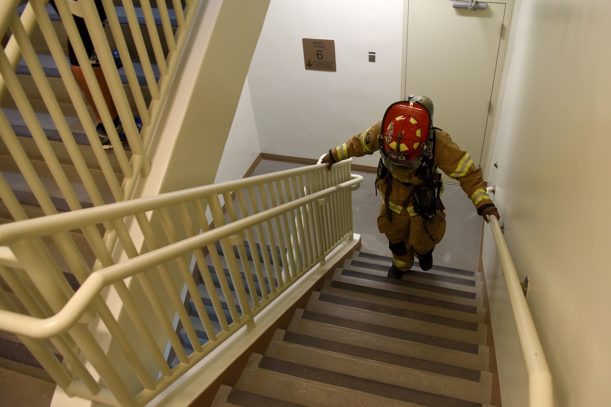 A U.S. Air Force firefighter with the 51st Civil Engineer Squadron walks up a flight of stairs during a 9/11 memorial stair climb at Seoraksan Tower on Osan Air Base, Republic of Korea, Sept. 11, 2018. Participants climbed the tower’s eight stories 16 times, totaling up to 112 flights overall. (U.S. Air Force photo by Senior Airman Kelsey Tucker)