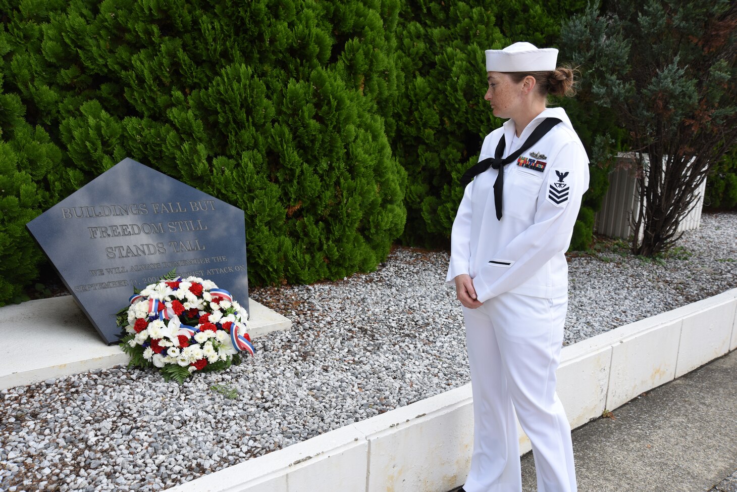 FLEET ACTIVITIES YOKOSUKA, Japan (Sept. 11, 2018) Chief (Select) Fire Controlman Gina Champion, assigned to Commander, Submarine Group 7, pauses at a memorial in front the Chief Petty Officer Club during a ceremony to commemorate the 17th anniversary of the Sept. 11 terrorist attack. Dozens of chief petty officers and selectees from USS Blue Ridge (LCC 19), U.S. 7th Fleet, Commander, Submarine Group 7, Commander, Fleet Activities Yokosuka and Commander, Naval Surface Group Western Pacific participated in the memorial ceremony, which included morning colors, a wreath-laying and first-hand accounts.