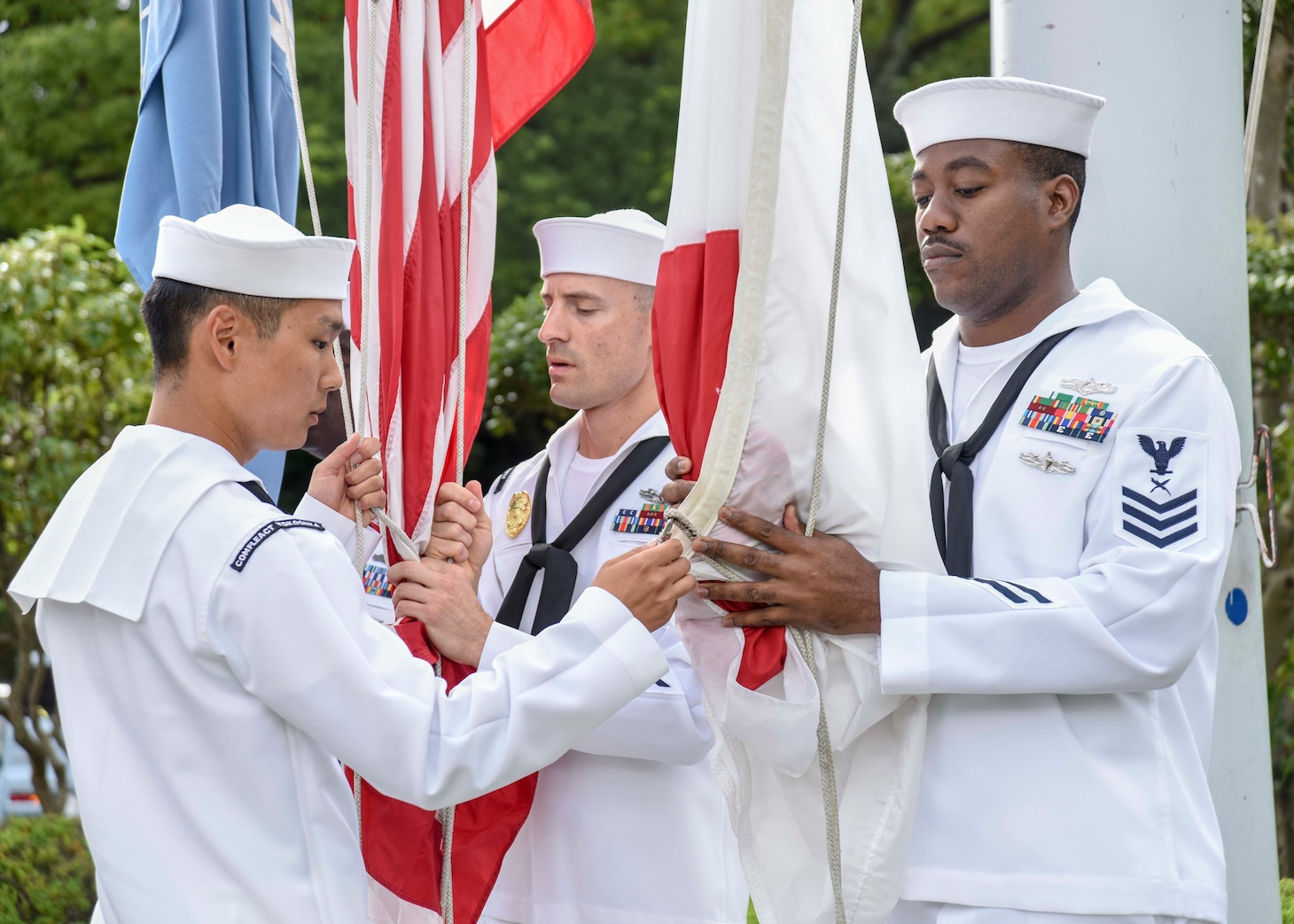 FLEET ACTIVITIES YOKOSUKA, Japan (Sept. 11, 2018) Chief petty officer selectees from Yokosuka-area commands perform morning colors at the Commander, Naval Forces Japan flagpole as part of a ceremony to commemorate the 17th anniversary of the Sept. 11 terrorist attack. Dozens of chief petty officers and selectees from USS Blue Ridge (LCC 19), U.S. 7th Fleet, Commander, Submarine Group 7, Commander, Fleet Activities Yokosuka and Commander, Naval Surface Group Western Pacific participated in the memorial ceremony, which also included a wreath-laying and first-hand accounts.