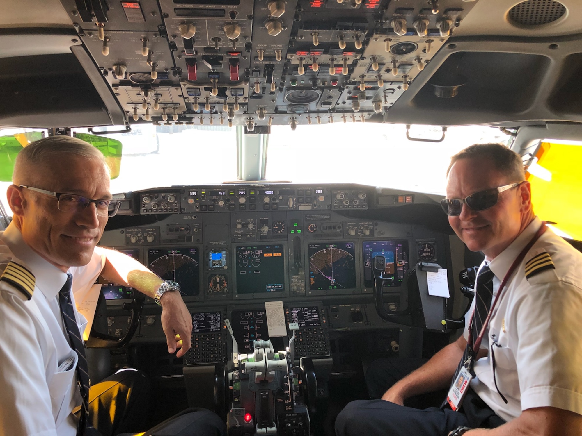 Maj. Gen. Craig La Fave, 22nd Air Force commander, left, poses in the flight deck of a United Airlines Boeing 737 with fellow Air Force Reservist and former 22nd AF vice commander, retired Air Force Col. Louis Patriquin, during an airline trip in July 2018. (Courtesy photo)