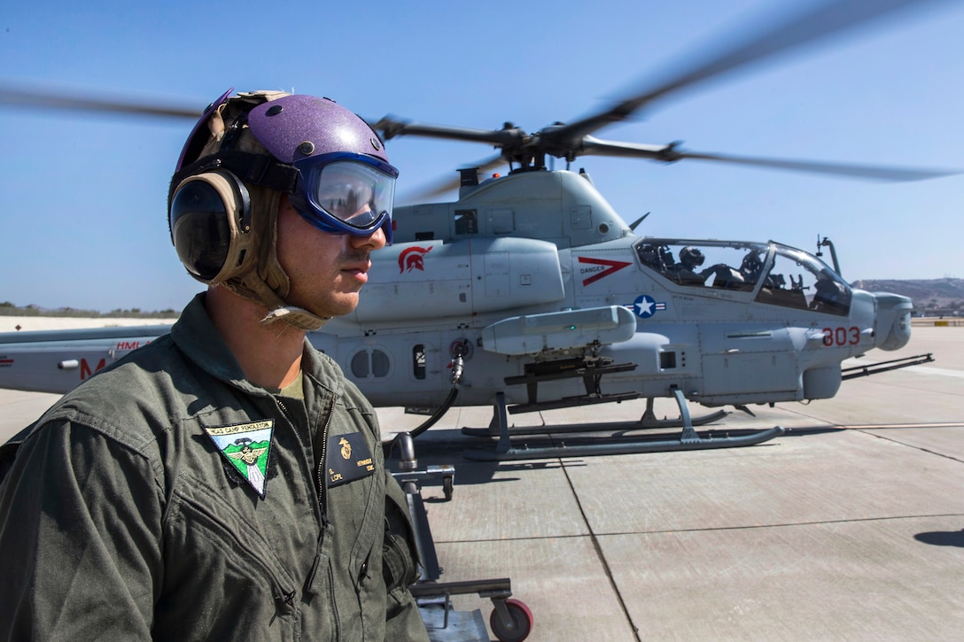 A Marine refuels an AH-1Z Viper Attack helicopter before a flight mission.