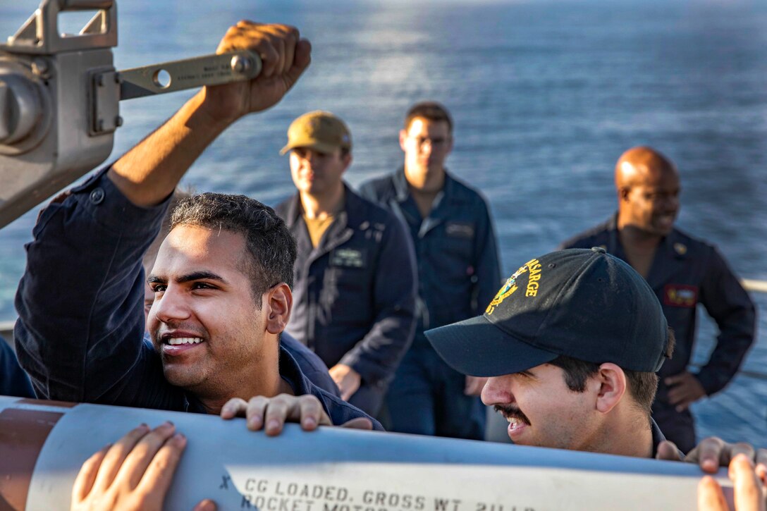 Sailors aboard the amphibious assault ship USS Kearsarge prepare to load a surface launch missile.