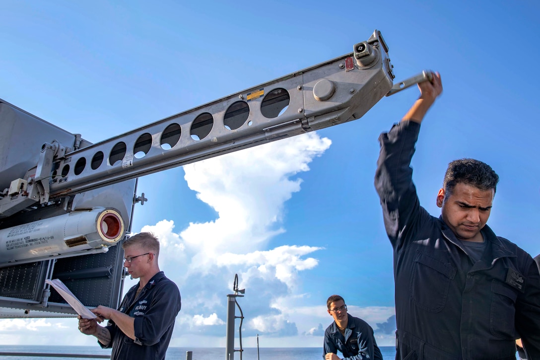 Sailors aboard the amphibious assault ship USS Kearsarge finish loading a surface launch missile.