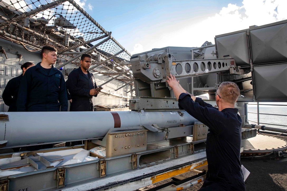 Sailors prepare a NATO Sea Sparrow missile launcher to be loaded with a RIM-7P surface launch missile.