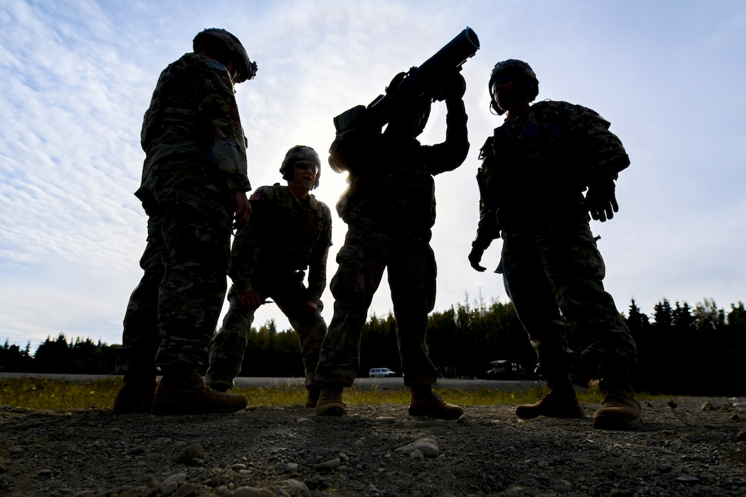 Soldiers train with an extra large rifle.