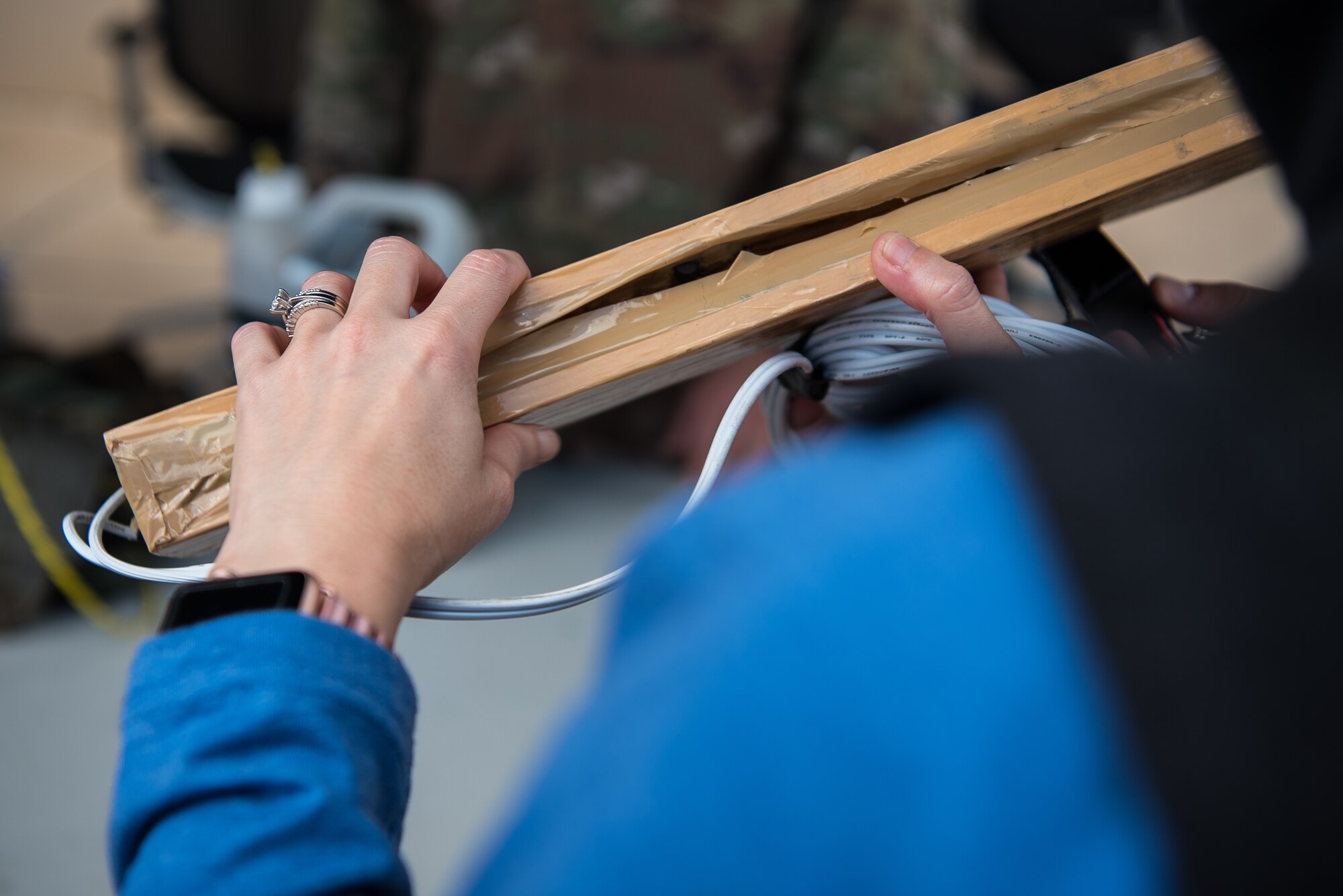 Rebekah Mitchell, Portales High School teacher, holds a model pressure plate provided by the 27th Special Operations Civil Engineer Squadron Explosive Ordnance Disposal team at Cannon Air Force Base, N.M., Sept. 8, 2018. The EOD team explained what they would see while deployed, and what equipment they would bring with them. (U.S. Air Force photo by Airman 1st Class Vernon R. Walter III/Released)