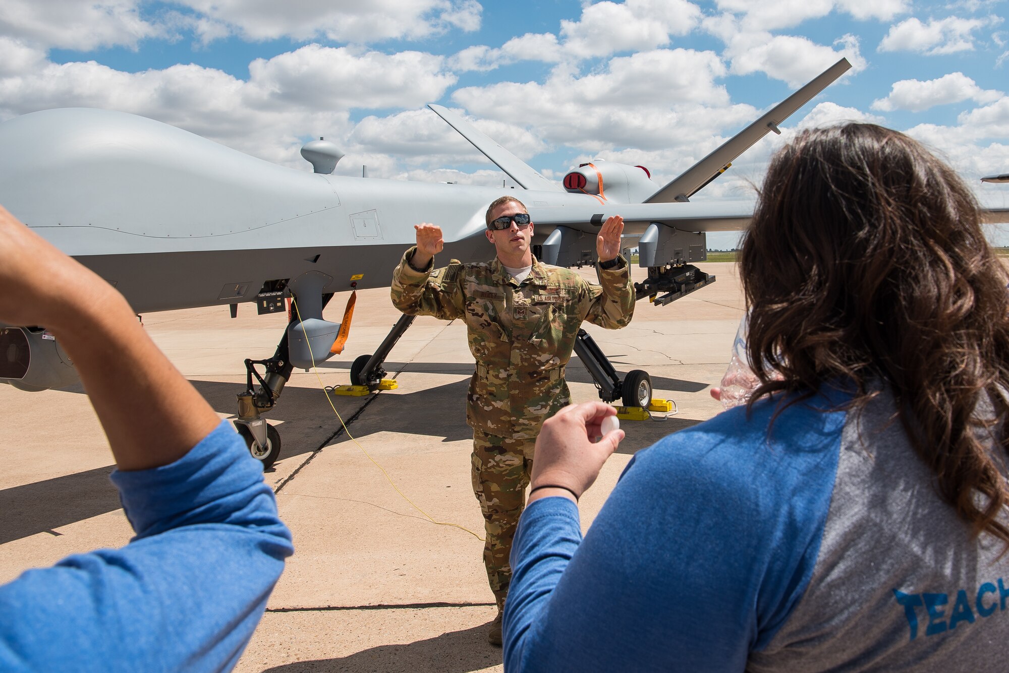 Staff Sgt. Jordon Reiley, 33rd Special Operations Squadron remotely-piloted aircraft operator, explains how the MQ-9 Reaper operates to participants of the Teachers Understanding Deployment Operations program at Cannon Air Force Base, N.M., Sept. 8, 2018. The TUDOS program gave staff from local schools the chance to understand a deployment works so they can support children of deployed military parents. (U.S. Air Force photo by Airman 1st Class Vernon R. Walter III/Released)