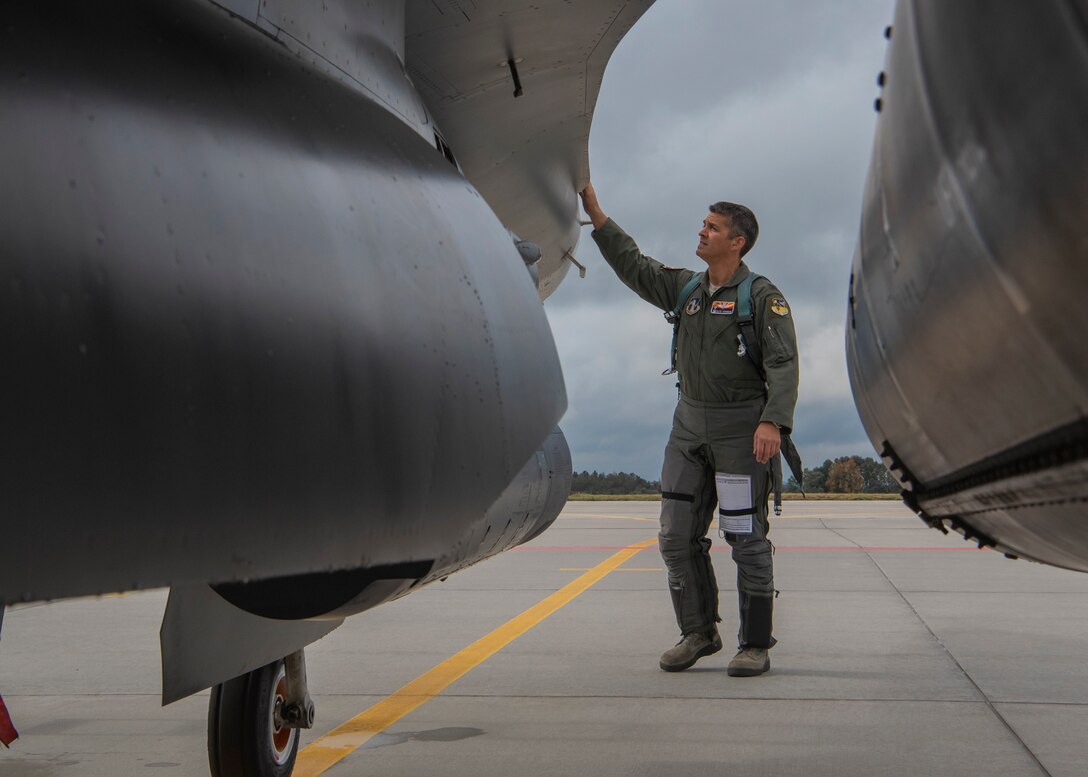 Colonel Allen Kinnison, 162nd Operations Group commander, Arizona Air National Guard, completes his pre-flight inspection of an F-16C Fighting Falcon at Namest Air Base, Czech Republic. Pilots accomplish a pre-flight inspection of each aircraft they will fly to ensure it is ready and safe for flight. Ample Strike is a Czech Republic led, multi-national live exercise that offers advanced air/land integration training to Joint Terminal Attack Controllers (JTACs) and Close Air Support (CAS) aircrews. The forward presence of the 162nd Wing, Arizona Air National Guard aircraft and Airmen in Europe allows the United States to work closely with our allies and partners to develop and improve interoperobility and maintain regional security. (U.S. Air National Guard photo by Staff Sgt. George Keck)