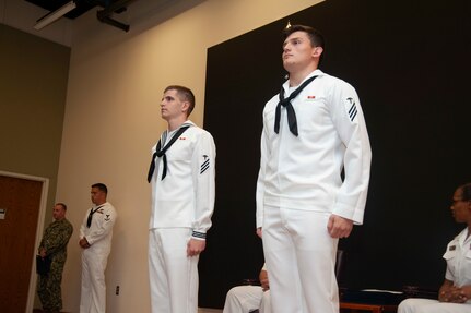 Seaman Nicholas Earls (left) and Seaman Enea Preci (right), are recognized during their graduation at the Medical Education and Training Campus. The two Sailors acted as first responders, assisting a patient who collapsed at the Veterans Affairs Emergency Room Aug. 27.