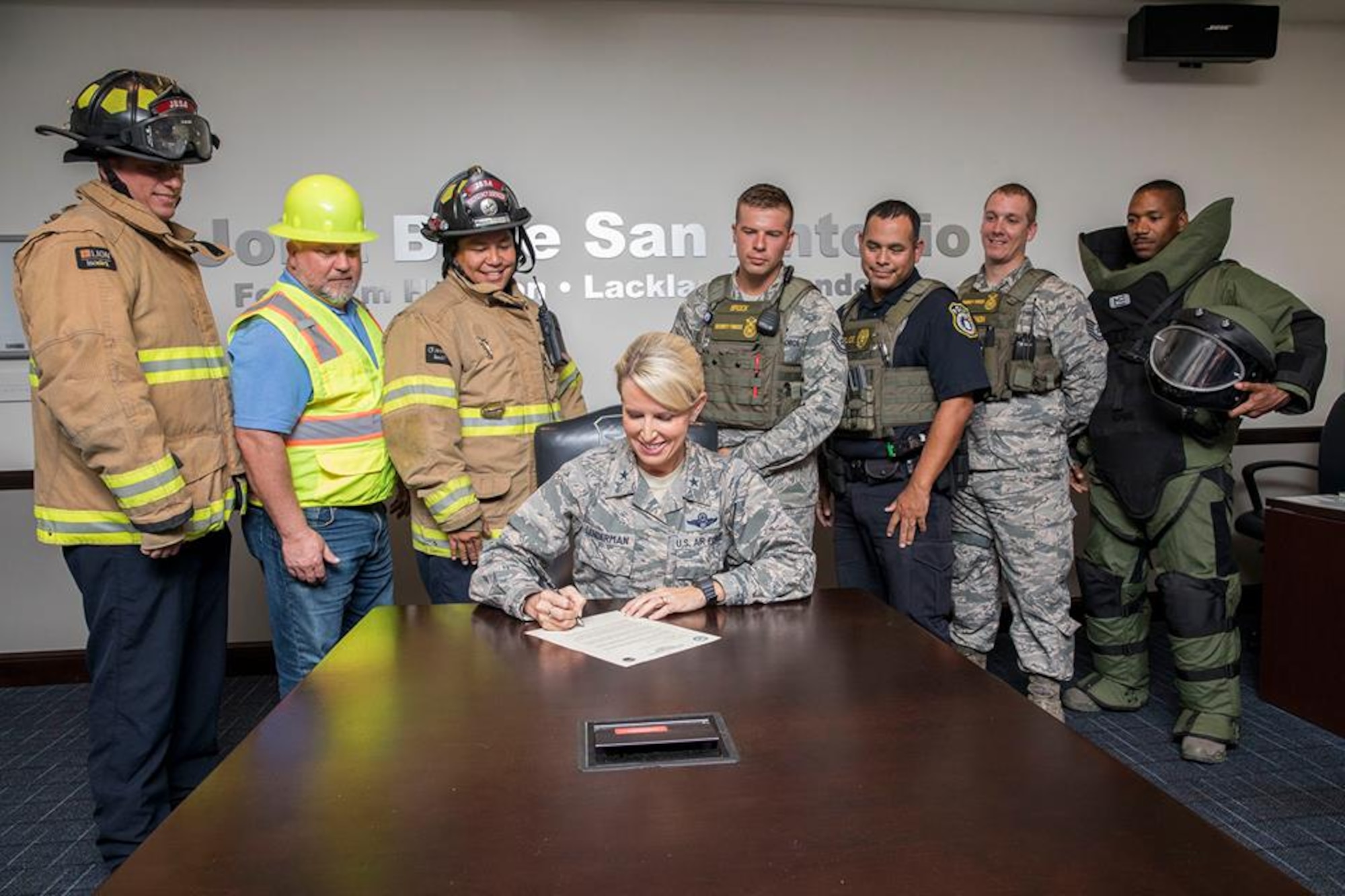 Brig. Gen. Laura L. Lenderman (center), commander, 502nd Air Base Wing and Joint Base San Antonio, signs the 2018 National Preparedness Month proclamation at the 502nd ABW conference room. The general is joined by (from left) Matthew Lucido, JBSA-Fort Sam Houston Firefighter; John Patrick, JBSA-Fort Sam Houston CE Structure Superintendent; Randy Simeon, JBSA-Fort Sam Houston Firefighter; Tech. Sgt. Tyler Brock, 502d SFS Flight Chief; Officer Patrick Villarreal, 502d SFS; William Vernon, 502d SFS Flight Chief; and Staff Sgt. Rhon Dawkins, 902d CES Explosive Ordnance Disposal Team Leader.
