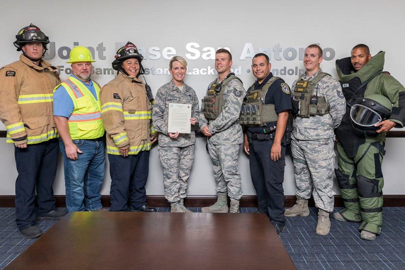 Brig. Gen. Laura L. Lenderman (center), commander, 502nd Air Base Wing and Joint Base San Antonio, is joined after signing the 2018 National Preparedness Month proclamation at the 502nd ABW conference room, by (from left) Matthew Lucido, JBSA-Fort Sam Houston Firefighter; John Patrick, JBSA-Fort Sam Houston CE Structure Superintendent; Randy Simeon, JBSA-Fort Sam Houston Firefighter; Tech. Sgt. Tyler Brock, 502d SFS Flight Chief; Officer Patrick Villarreal, 502d SFS; William Vernon, 502d SFS Flight Chief; and Staff Sgt. Rhon Dawkins, 902d CES Explosive Ordnance Disposal Team Leader.