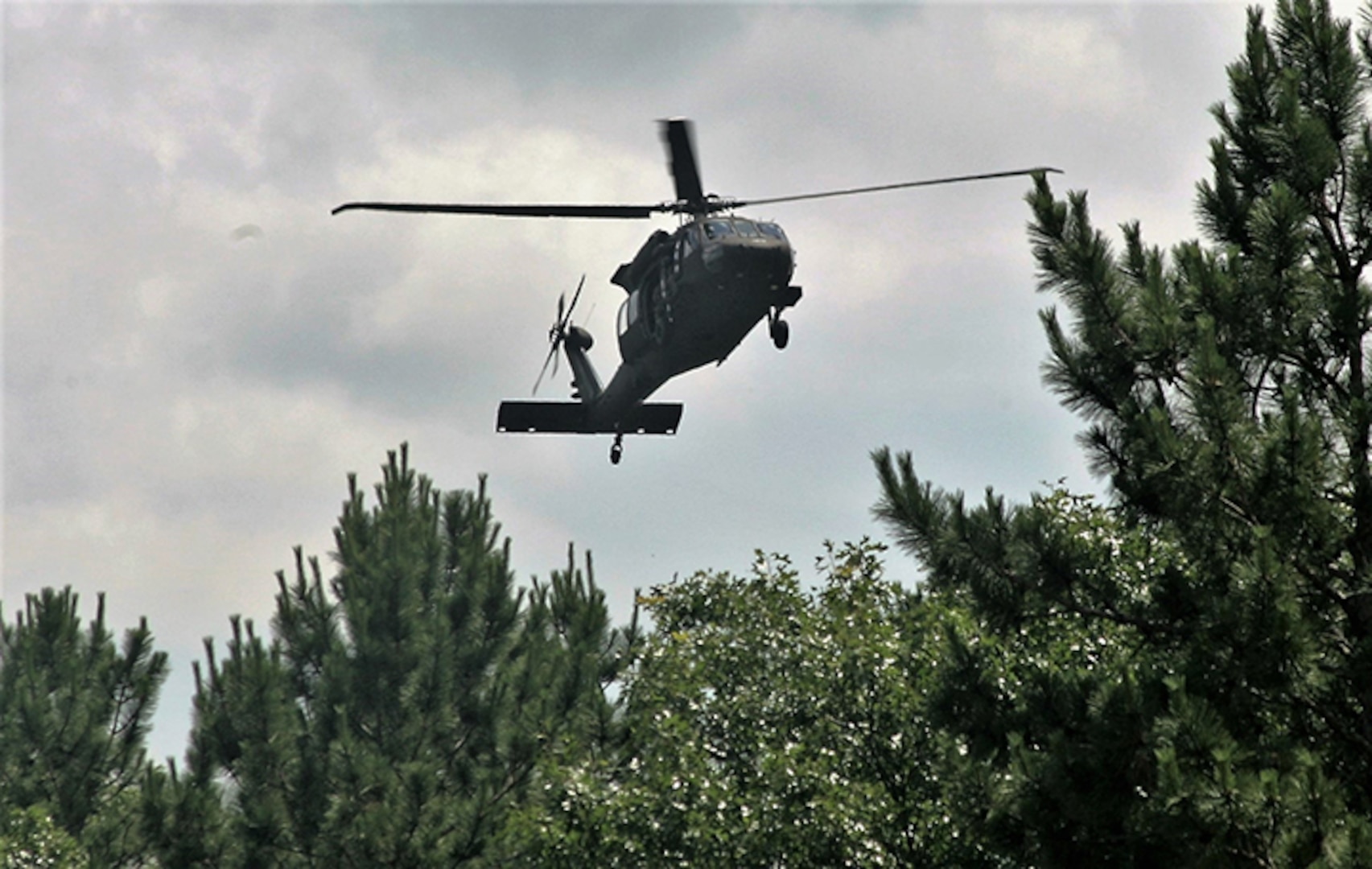 A UH-60 Black Hawk helicopter operated by a crew with the Wisconsin Army National Guard flies over the Combined Arms Collective Training Facility on June 28, 2018, at Fort McCoy, Wis. A Black Hawk crew rescued two men stranded in a marshland.