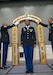 Sgt. Angela Johnson, G-6, 1st Theater Sustainment Command, walks under crossed sabers as a symbol she crossed the threshold from Soldier to noncommissioned officer during the 1st TSC induction ceremony March 2, 2018 at Fort Knox, Ky.