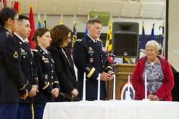 Fort Knox, Ky. - Maj. Gen Flem B. "Donnie" Walker Jr., commanding general, 1st Theater Sustainment Command, lights a candle April 20 during the 2018 Days of Remembrance Commemoration Program, as Wanda Wolosky, right, a Warsaw ghetto survivor, looks on.