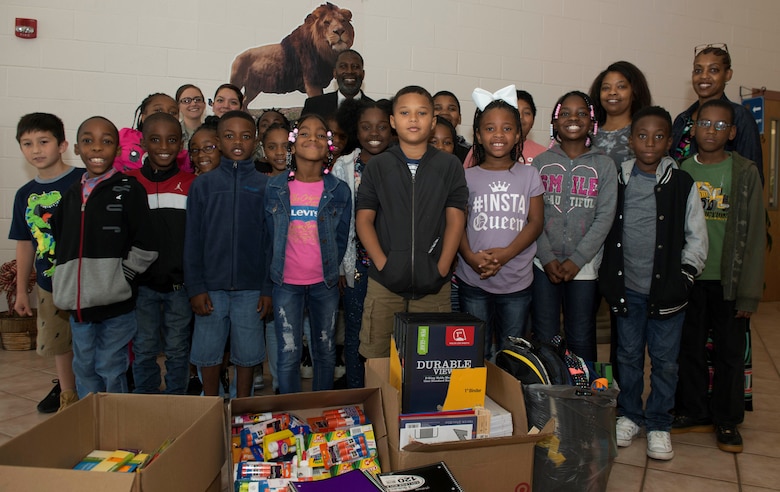 Members of Rafting Creek Elementary School and Shaw Air Force Base (AFB) stand with school supplies in Sumter, S.C., Sept. 10, 2018.