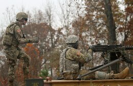 Sgt. Austin Ball, a network assurance noncommissioned officer for the 1st Theater Sustainment Command, coaches Pfc. Dontrez Dawson, an administrative specialist for the secretary of the general’s staff, 1st TSC, as he fires a M2 .50-caliber machine gun Nov. 6 at Heins Range.