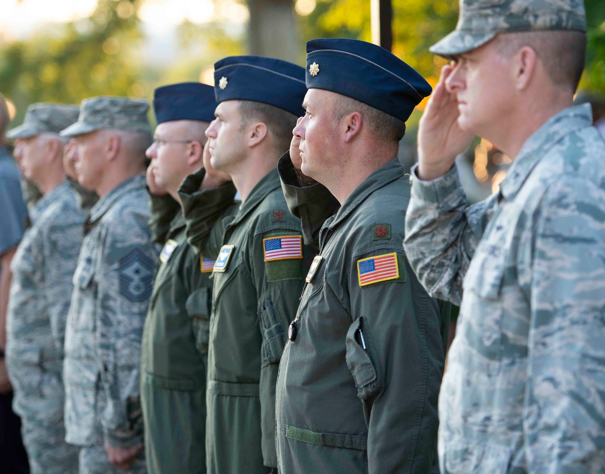 Scott Airmen salute the flag during a 9/11 memorial ceremony, Sept. 11, 2018, at Scott Air Force Base, Illinois. Following the raising of the flag, ceremony attendees remembered the victims of the 2001 terrorist attacks by participating in a moment of silence. (U.S. Air Force photo by Airman 1st Class Tara Stetler)