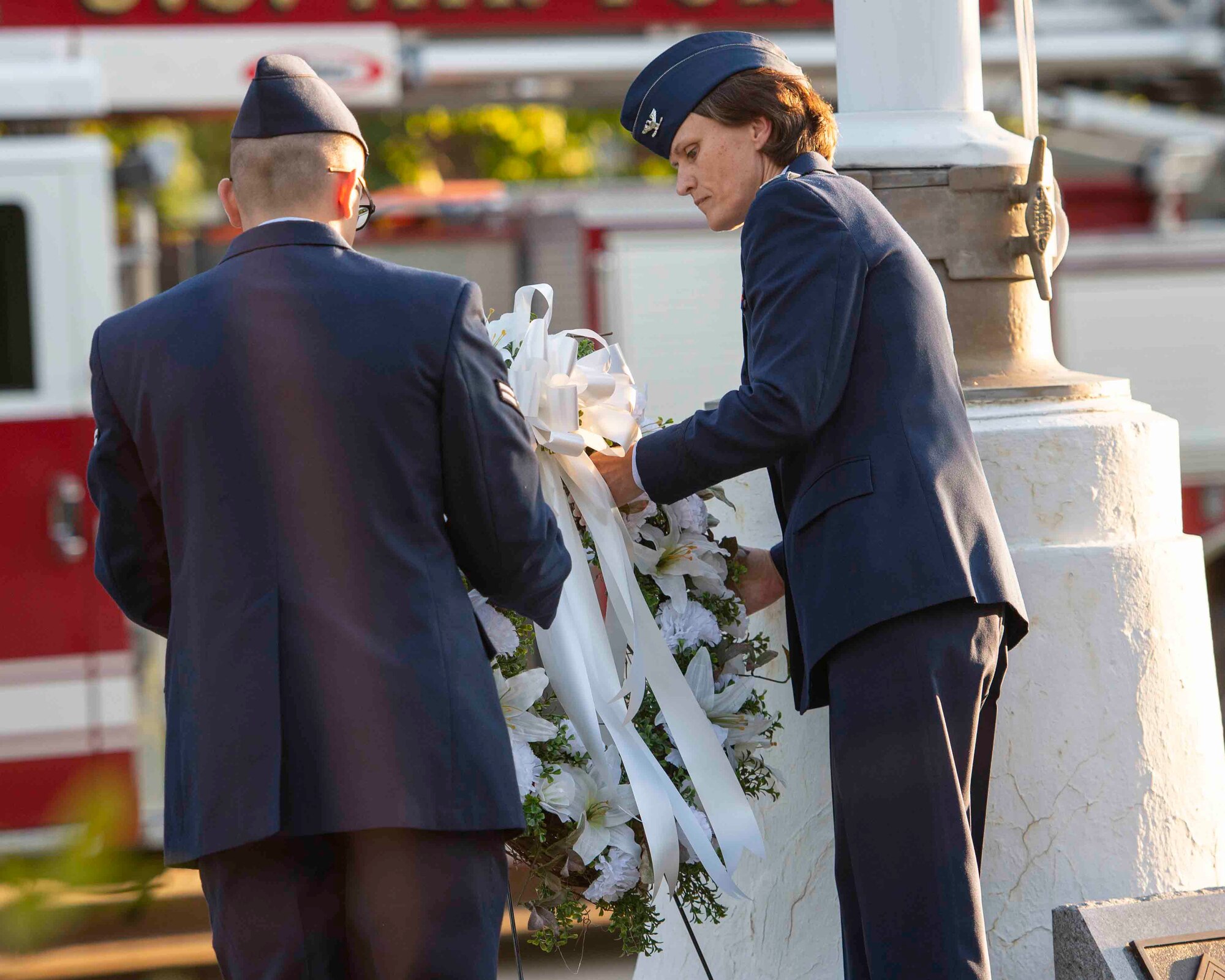 Col. Leslie Maher, 375th Air Mobility Wing commander, lays a wreath during a 9/11 memorial ceremony, Sept. 11, 2018, at Scott Air Force Base, Illinois. The wreath was meant to honor the 2,996 victims of the 2001 terrorist attacks. (U.S. Air Force photo by Airman 1st Class Tara Stetler)