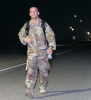 CAMP ARIFJAN, Kuwait - Sgt. 1st Class Keith Killgren, Strategic Operations and Plans (SOaP) communications noncommissioned officer in charge, 1st Theater Sustainment Command (TSC), rucks in the early morning hours during the annual Camp Arifjan Bataan Death March, Mar. 25, 2018. Killgren earned second place, finishing with a time of five hours, forty-seven minutes. (Courtesy photo, MWR)