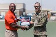 CAMP ARIFJAN, Kuwait - Sgt. 1st Class Keith Killgren, Strategic Operations and Plans (SOaP) communications noncommissioned officer in charge, 1st Theater Sustainment Command (TSC), accepts the award for second place in the annual Camp Arifjan Bataan Death March, Mar. 25, 2018. Killgren finished with a time of five hours, forty-seven minutes. (Courtesy photo, MWR)
