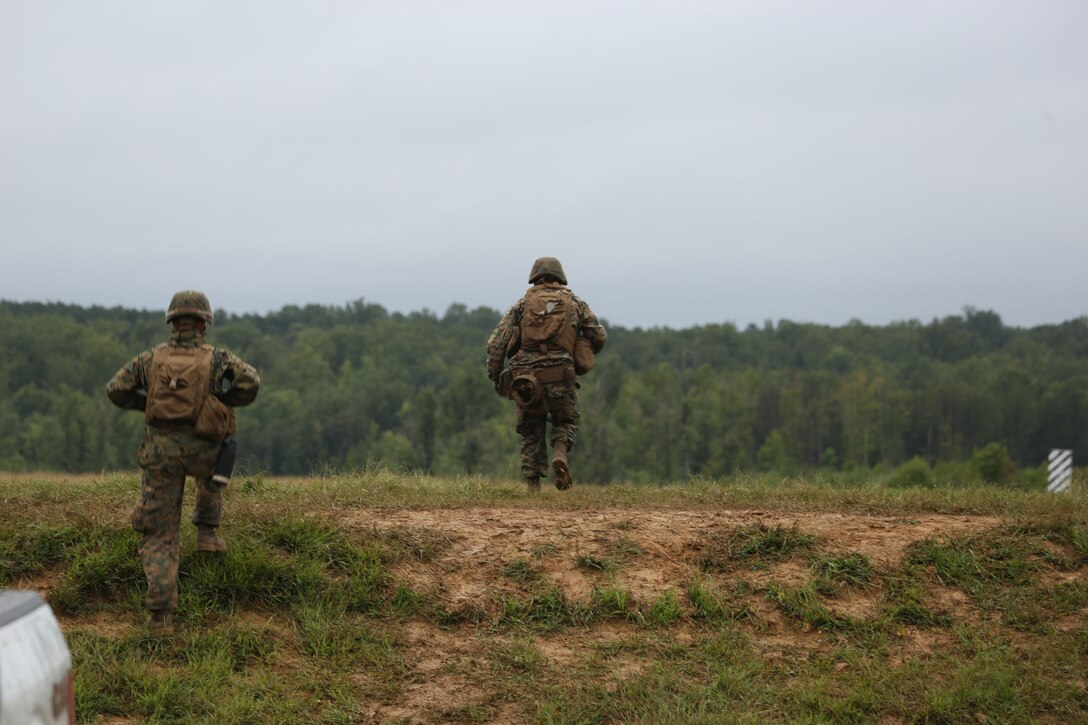 Marines from Marine Barracks Washington D.C. rushes over a berm during a live-fire training exercise for the Fire Team Leaders Course at Marine Corps Base Quantico, Va., Sept. 9, 2018. The course was comprised of multiple live-fire events utilizing numerous weapons systems, patrols and defensive and offensive drills. It is a course designed to strengthen small unit leadership amongst the Marines to prepare them for the Fleet Marine Forces, while focusing on refining their infantry skills.
