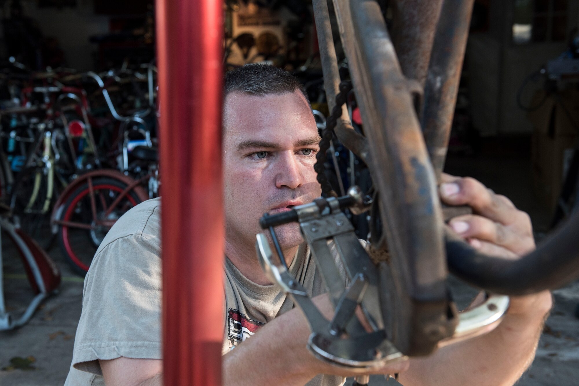 U.S. Air Force Staff Sgt. Patrick Lewis, 20th Equipment Maintenance Squadron aircraft structural maintenance mechanic, works on a bicycle at his home in Sumter, S.C., Sept. 10, 2018.