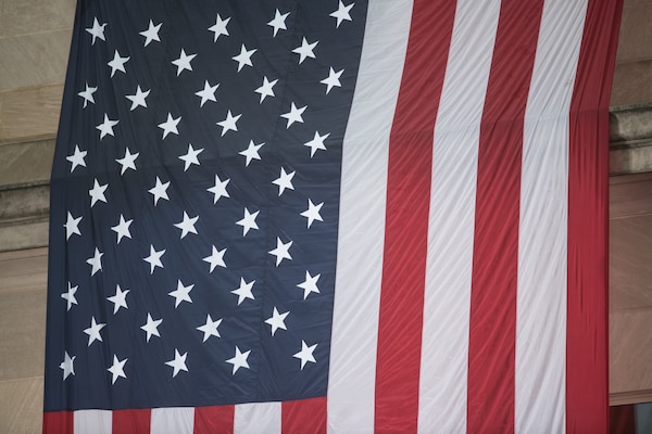 An American Flag hangs from the roof of the Pentagon before U.S. Secretary of Defense James N. Mattis and U.S. Air Force Gen. Paul J. Selva, Vice chairman of the Joint Chiefs of Staff, host U.S. Vice President Mike Pence,  at the Sept. 11 Pentagon Memorial Observance Ceremony at the Pentagon in Washington, D.C., Sept. 11, 2018. During the Sept. 11, 2001, attacks, 184 people were killed at the Pentagon.