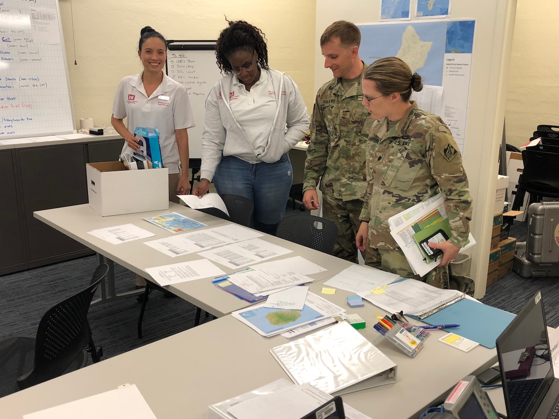 Honolulu District Commander Lt. Col. Kathryn Sanborn (right) and emergency management operations personnel analyzing the latest weather reports on Hurricane Olivia Sept. 10 in the District's EOC. Honolulu District activated its Emergency Operation Center  Sept. 6, 2018, in support of the response to Typhoon Mangkhut that ravaged the Commonwealth of the Northern Mariana Islands, and Hurricane/Tropical Storm Olivia that is heading for landfall in the eastern Hawaiian Islands.