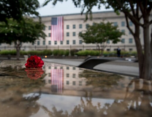 A red flower sits atop of every bench to remember the fallen on Sept. 11, 2001, during the Pentagon Memorial Observance Ceremony in Washington D.C., Sept. 11, 2018. Hundreds of military service members, family members who perished during the attacks, veterans and distinguished guests gathered to reflect on the lives lost during the attacks on Sept. 11, 2001.