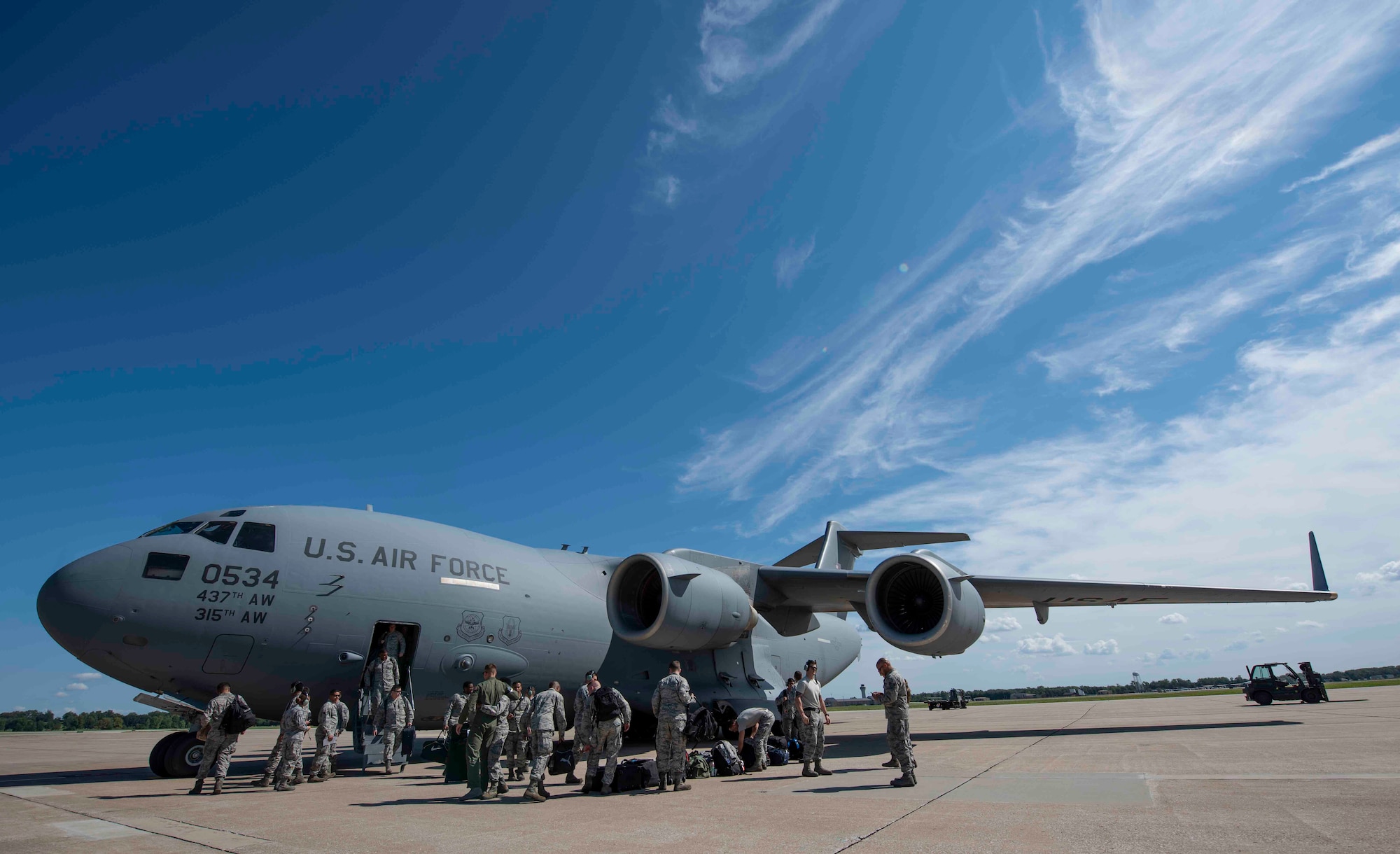 Airmen from Joint Base Charleston disembark a C-17 Globemaster III, Sept. 11, 2018, at Scott AFB, Illinois. Scott AFB teamed up with Mid-America Airport to host a fleet of C-17s assigned to the 437th Airlift Wing during Hurricane Florence evacuation efforts. (U.S. Air Force photo by Airman 1st Class Tara Stetler)