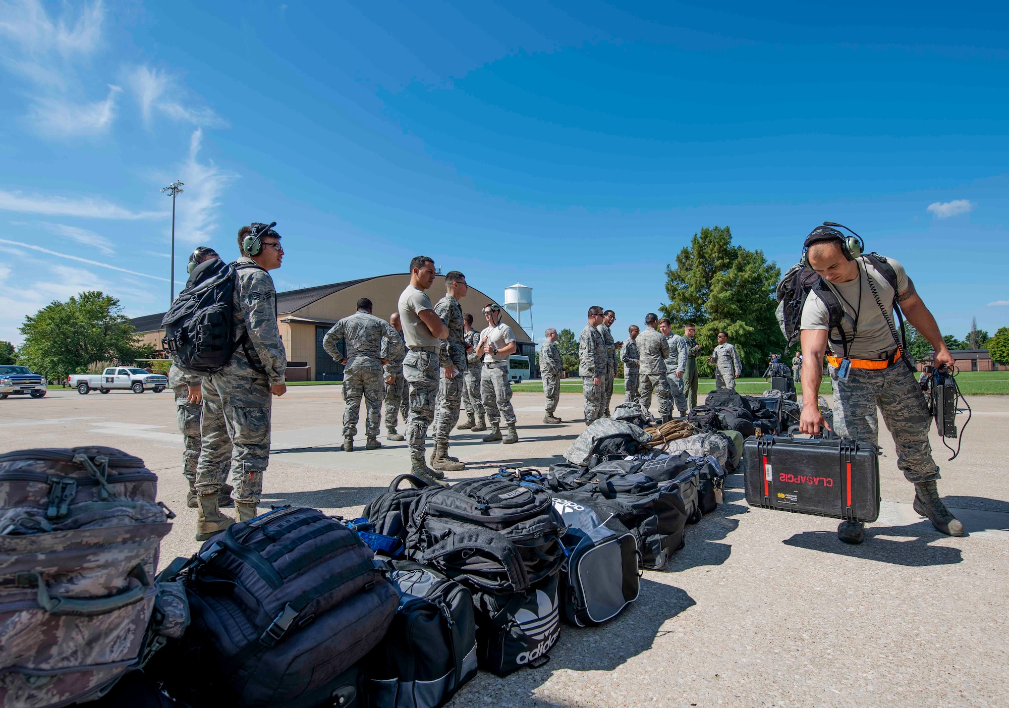 Airmen with Joint Base Charleston unload their gear off a C-17 Globemaster III assigned to the 437th Airlift Wing during Hurricane Florence evacuation efforts, Sept. 11, 2018, at Scott AFB, Illinois. The purpose of the evacuation is to protect people and assets from the storm. (U.S. Air Force photo by Airman 1st Class Tara Stetler)