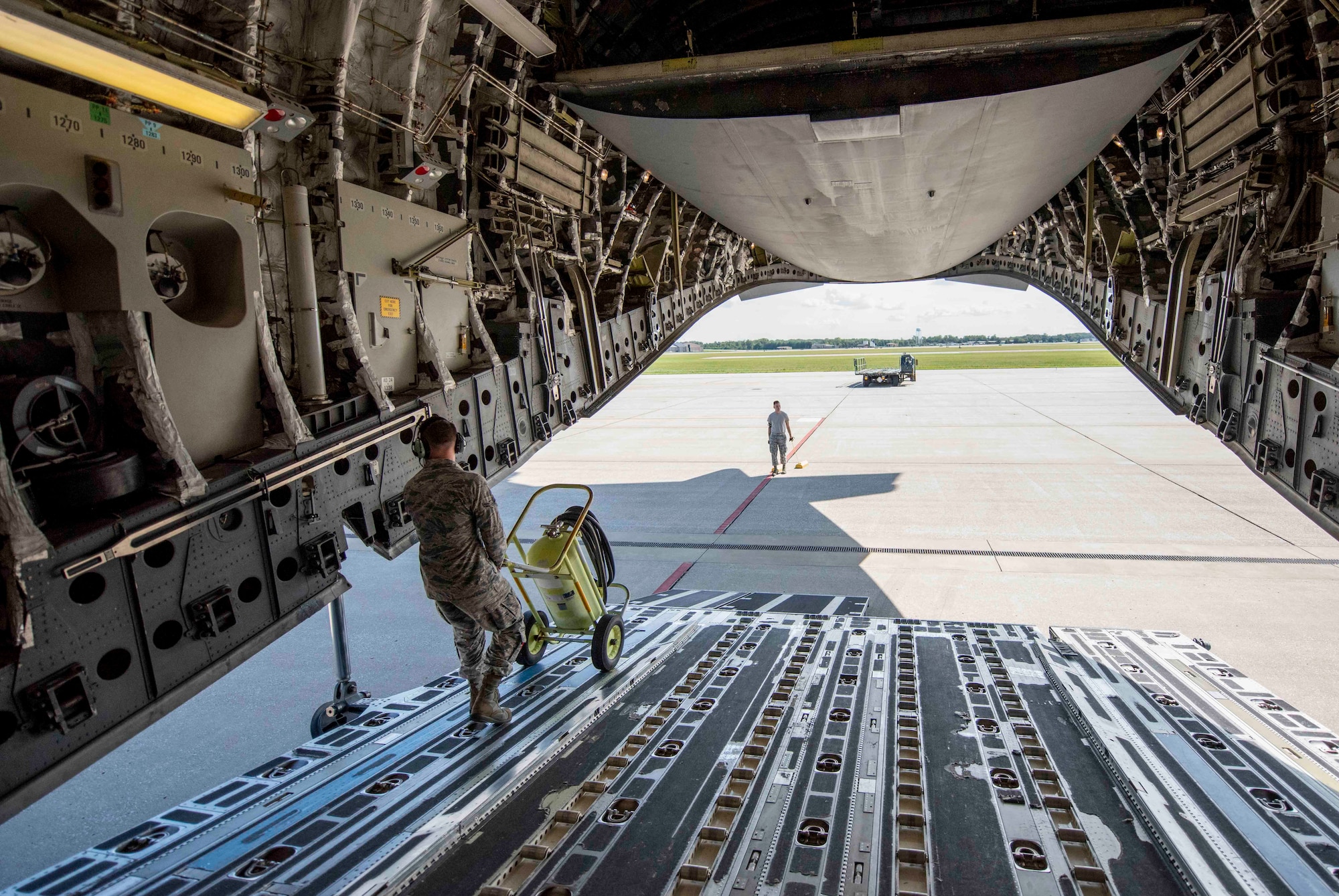 Airmen from Joint Base Charleston and Scott AFB team up to unload a C-17 Globemaster III assigned to the 437th Airlift Squadron during Hurricane Florence evacuation efforts, Sept. 11, 2018, at Scott AFB, Illinois. More than 1 million people have been ordered to evacuate Virginia, North Carolina and South Carolina in preparation of the Category 4 storm. (U.S. Air Force photo by Airman 1st Class Tara Stetler)