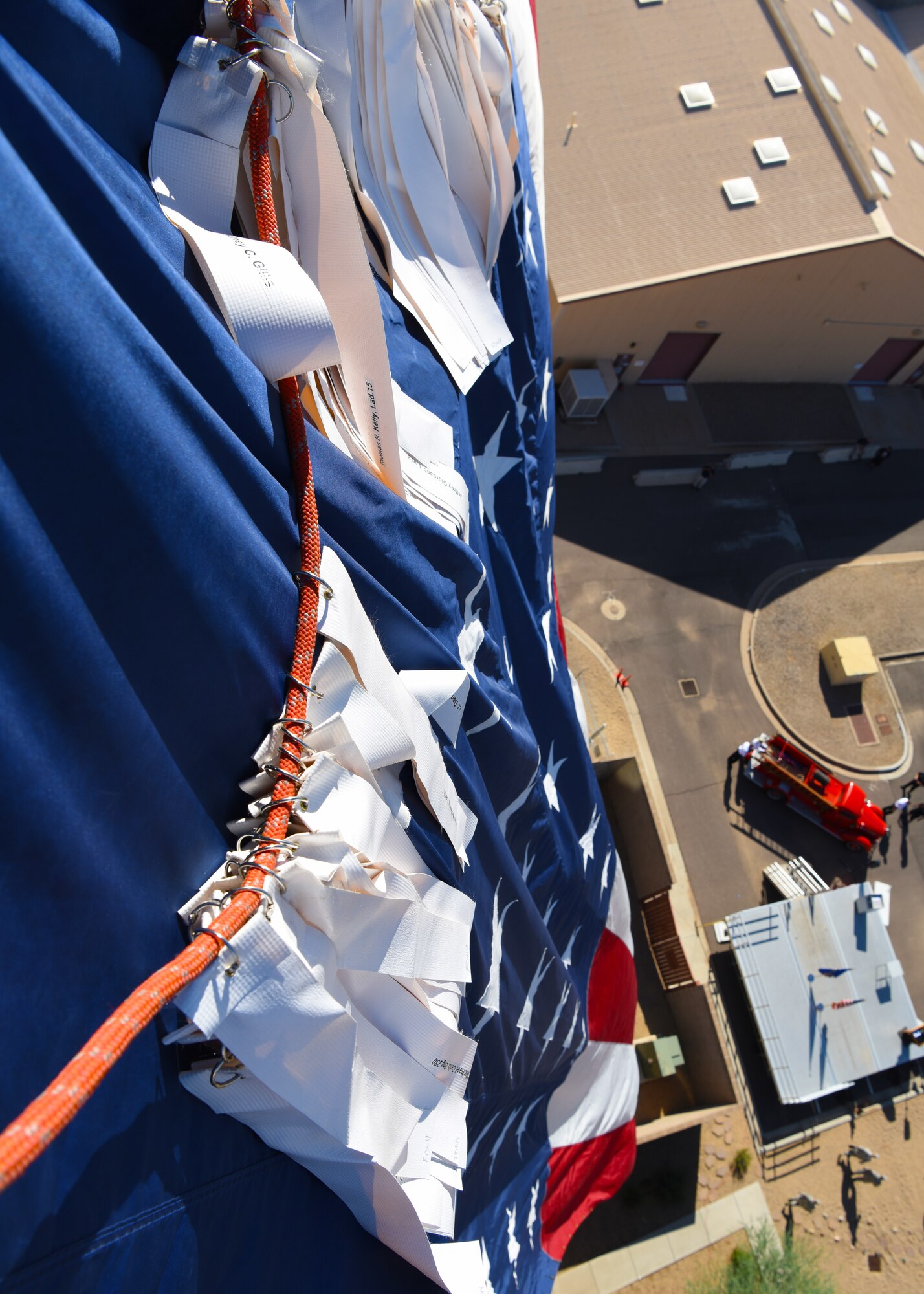 Names of the fallen first responders of 9/11 hang from streamers over the American Flag Sept. 11, 2018 at Luke Air Force Base, Ariz. Airmen carried more than 400 streamers to the top of the air traffic control tower in remembrance of the lives of first responders lost on 9/11. (U.S. Air Force photo by Airman 1st Class Aspen Reid)