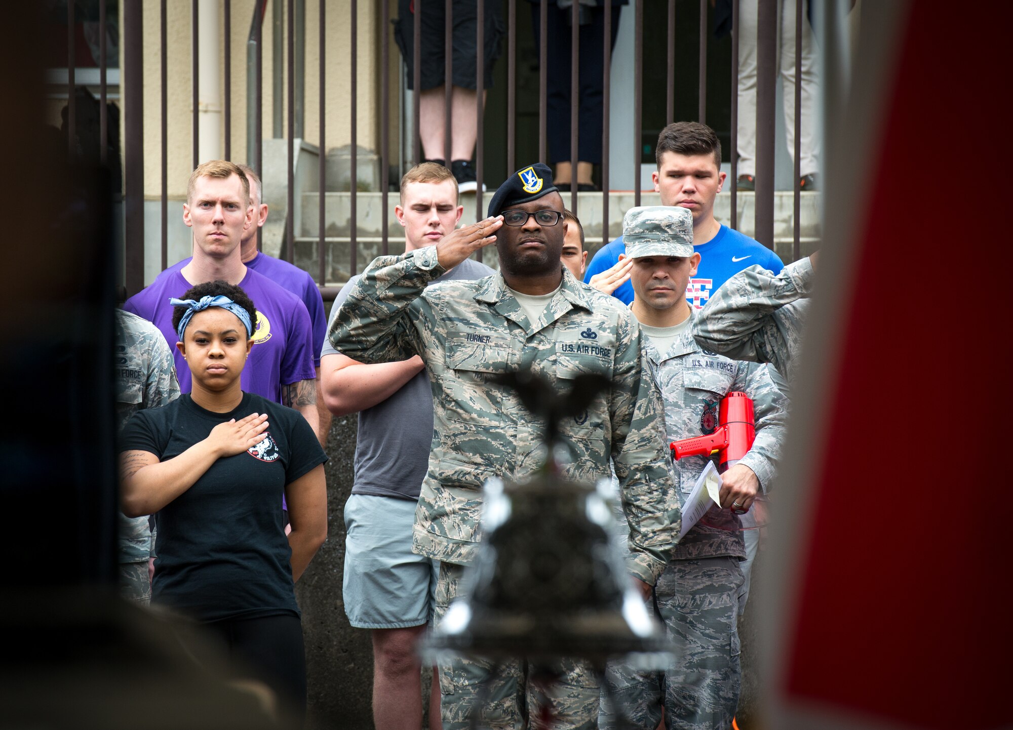 Master Sgt. Tyson Turner, 374th Security Forces Squadron superintendent of logistics and readiness, salutes during the playing of the Japanese and American National Anthems