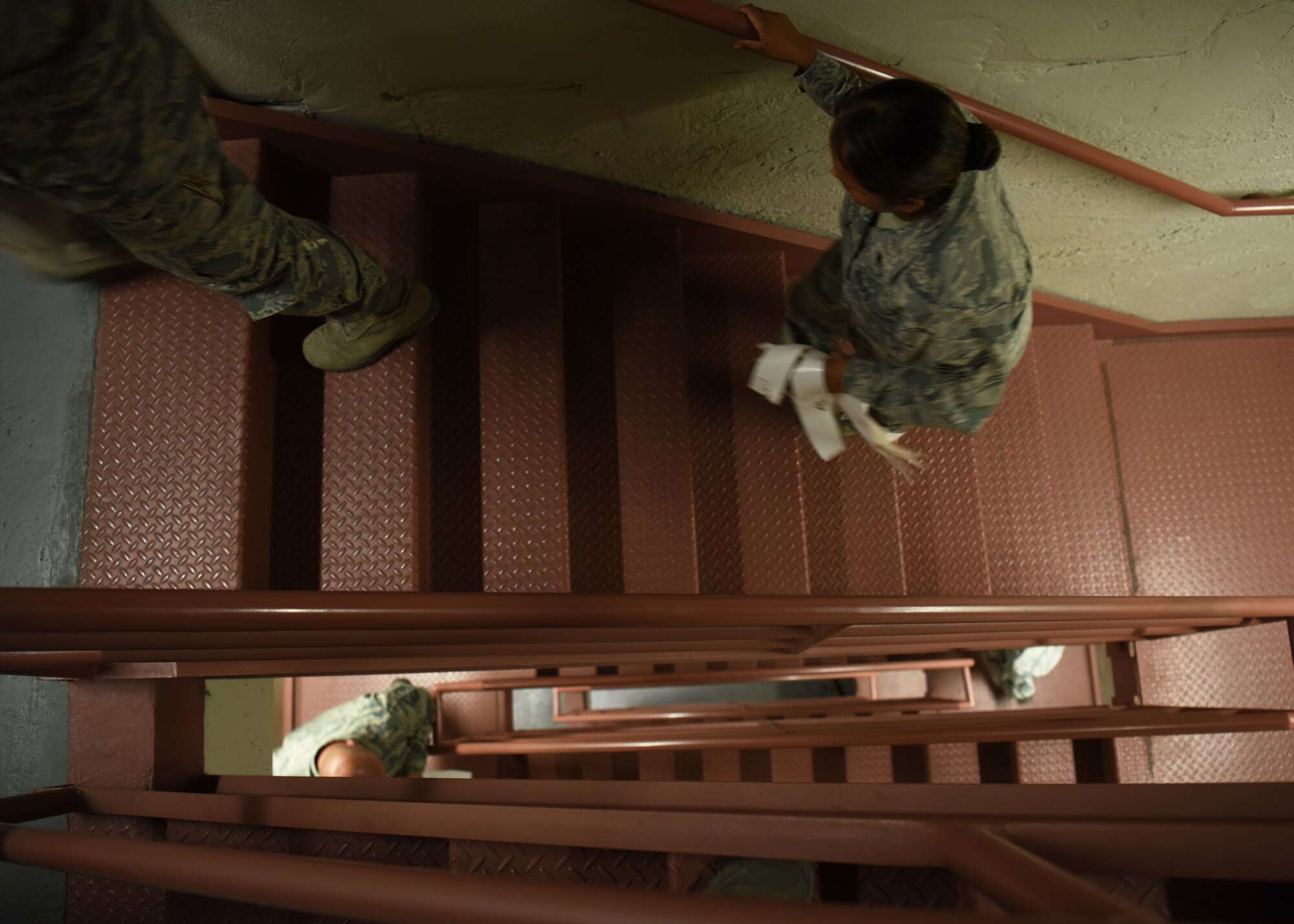 Service members of the 56th Fighter Wing climb to the top of the air traffic control tower during a 9/11 Tribute Tower Climb Sept. 11, 2018 at Luke Air Force Base, Ariz. Thunderbolts carried the names of the first responders who lost their lives on streamers to be hung with the American Flag at the top of the tower. (U.S. Air Force photo by Airman 1st Class Aspen Reid)