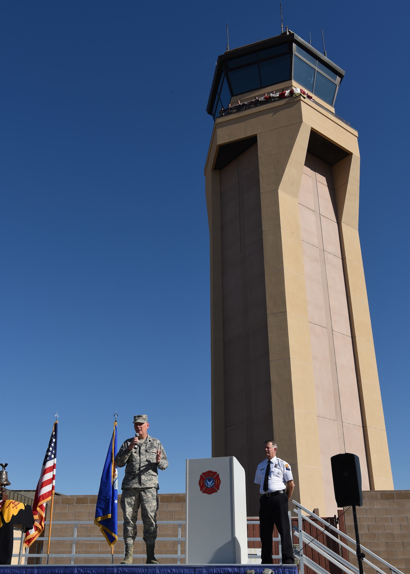Col. Robert Sylvester, 56th Mission Support Group commander, addresses a crowd at the 9/11 Remembrance Ceremony before a Tribute Tower Climb Sept. 11, 2018 at Luke Air Force Base, Ariz. The Tribute Tower Climb was held in Luke’s air traffic control tower where Thunderbolts climbed 10 flights of stairs to the top of the tower to hang 411streamers representing the emergency responders who lost their lives during the Sept. 11, 2001 attacks on the United States. (U.S. Air Force photo by Airman 1st Class Aspen Reid)